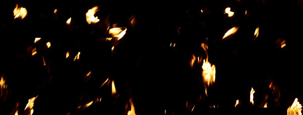 fire and flame debris falling to the ground overlay over a black background